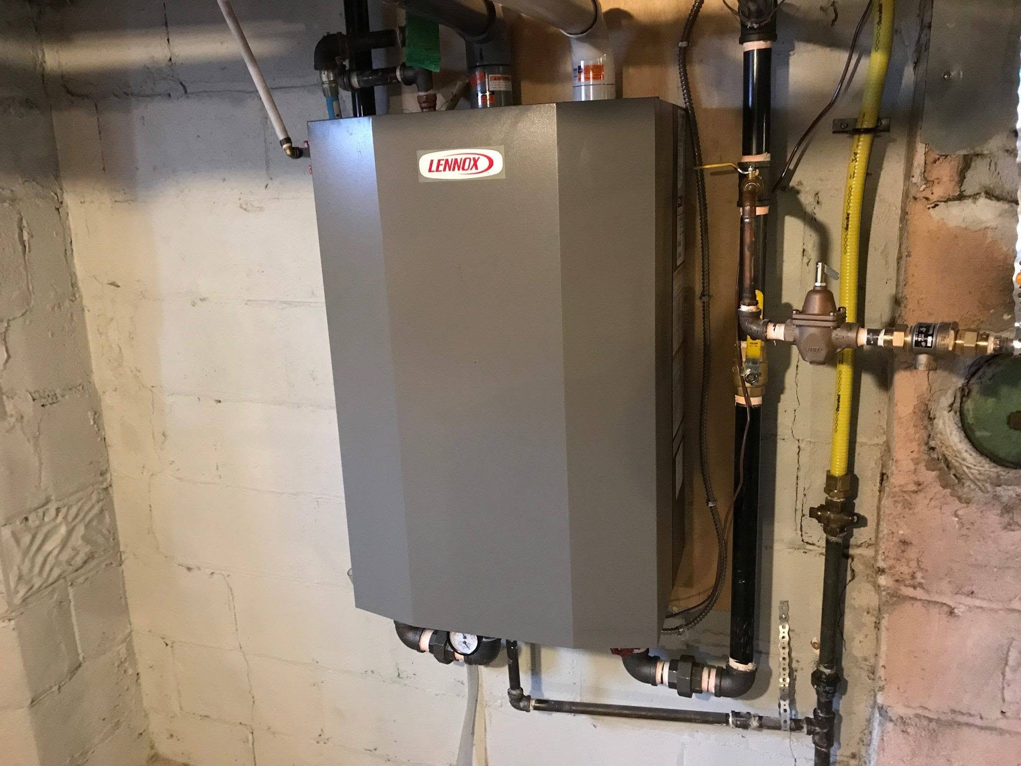 Lennox tankless water heater installation with gas line and plumbing connections